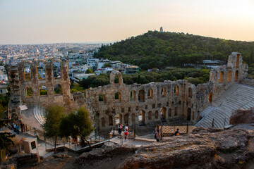 Obraz na płótnie Canvas The Odeon of Herodes Atticus ( Herodeion) is a stone Roman theater structure located on the southwest slope of the Acropolis of Athens, Greece. sunset time