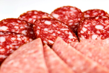 Sliced salami sausage close-up on a plate.