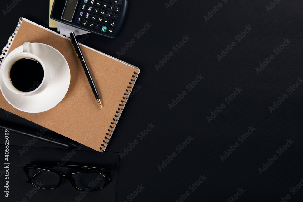 Poster coffee on notepad with calculator on black table