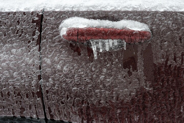 Frozen car door closeup, icicles, ice crystals, jammed lock