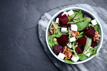 Delicious beet salad served on black table, top view. Space for text