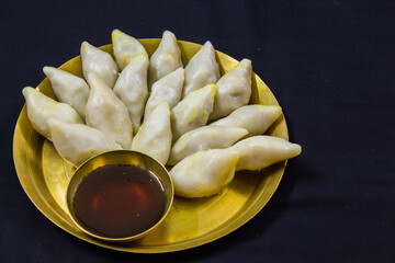delicious bengali rice flour coconut dumpling served during bengali indian festival of makar...
