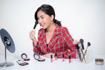 Asia woman beauty blogger does make up, reviews beauty product for video blog, gives advice to...