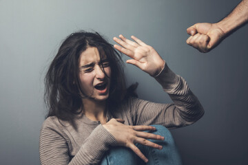 man beating crying young woman