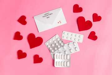 Conceptual Valentine's day medical composition. Red hearts next to the healing pills. Covid-19 Valentine's day. Image for pharmacy, hospitals, medicine