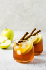 Delicious refreshing summer apple cinnamon iced tea in glasses. Space ofr text.