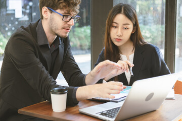 Business professional people group, team of young asian, caucasian working and communicating, analyzing data, discussing, using laptop computer explain about new project with colleagues in workplace.