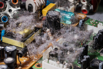 Very dusty old circuit board of electronic device illustrating concept of planned obsolescence