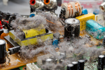 Very dusty old circuit board of electronic device illustrating concept of planned obsolescence