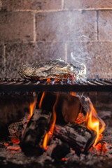 steel grilled meat burger with wood flame fries in metallic foil herbs oregano onions cordoba argentina