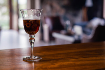 crystal glass on bar counter with bokehe bottom and ice cordoba argentina