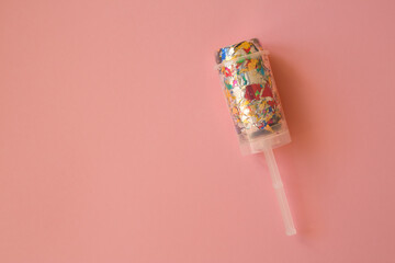 
Multicolored candy in a package on a pink background. Candy is the best decor for your merry...
