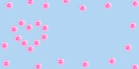 Valentine's Day banner background. Pink roses in the shape of a heart on a pastel blue background with copy space.