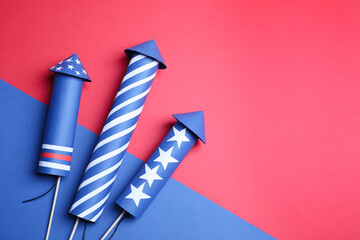 Firework rockets on color background, flat lay. Space for text