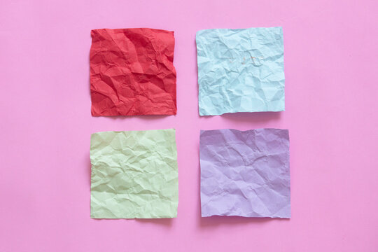 Four Crumpled Note Paper On Pink Background