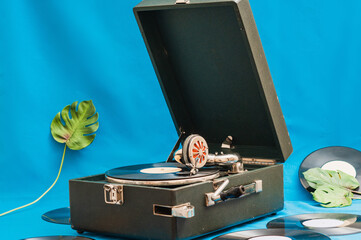 Vintage vinyl record player with monsters leaf. Vinyl records on