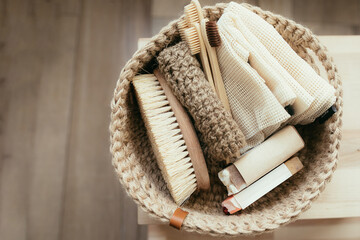 Fototapeta premium Natural product in jude basket. Bodybrush, toothbrush, shopping bag, soap. Treat yourself concept