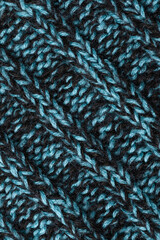 top view of a knitted woolen blanket. Melange background with intertwined threads