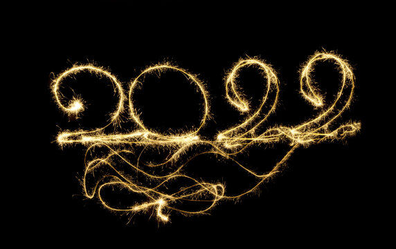 Happy new year 2022. drawing at night with sparklers. Numbers 2022. Long exposure in the photo. the magic of Christmas new year holidays. Congratulation, postcard.