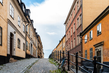 Picturesque cobblestoned street with colorful houses in Ugglan quarter in Sodermalm in Stockholm