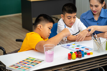 Asian disability child boy and Autism kid learning drawing in classroom