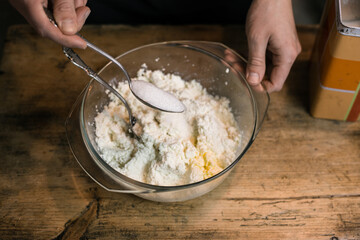 Adding sugar to curd with a spoon
