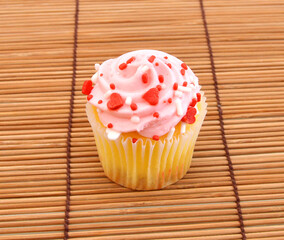 cupcake isolated over bamboo mat