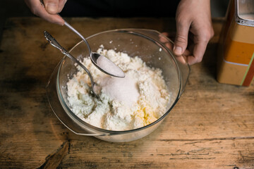 Adding sugar to curd with a spoon