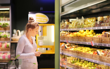 Woman buying fruits and vegetables at the market.