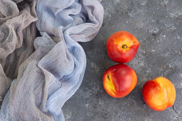 Fresh peaches and draping on the surface of the texture table. High quality photo