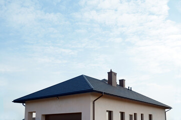 A fragment of the roof made of metal roof tiles. A newly built residential house.