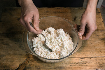 Stir the curd with a spoon in a glass bowl