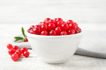 Tasty ripe cranberries on white wooden table, closeup