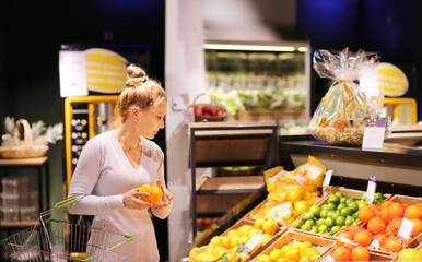 Woman buying fruits and vegetables at the market.
