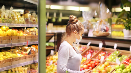  Supermarket shopping, face mask and gloves,woman buying vegetables at the market.