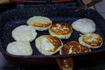 Fry cheese cakes at home in a pan