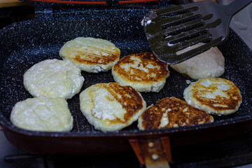 Fry cheese cakes at home in a pan