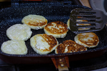Fry cheese cakes at home in a pan