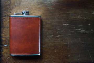 Hip flask on wooden table
