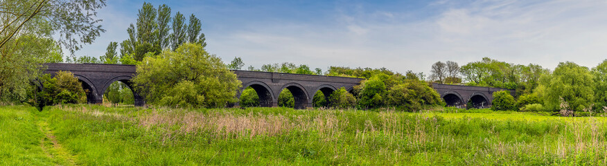 Fototapeta na wymiar A panorama view across the old railway viaduct at Thrapston, UK in springtime