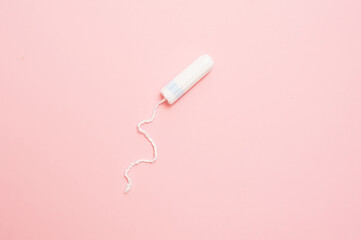 Clean white cotton tampons on pink background. Menstruation. Feminine Hygiene in periods, beauty treatment.