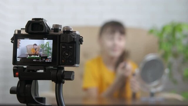 Blogging make up on camera. A teenage girl writes a block about cosmetics.