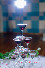 Champagne glass pyramid. Pyramid of glasses of wine, champagne, tower of champagne's glass in wedding reception party