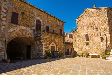 Fototapeta na wymiar Historic stone residential buildings in the village of Montemerano near Manciano in Grosseto province, Tuscany, Italy 