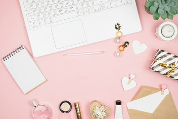 Shopping Online Concept. Womens hands with phone and laptop on pink background. Top view, copy space
