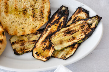 Grilled zucchini served with grains. Traditional Greek dish.