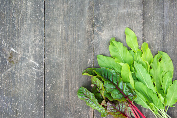 Fresh beetroot and sorrel leaves on the surface of an old wooden table. High quality photo