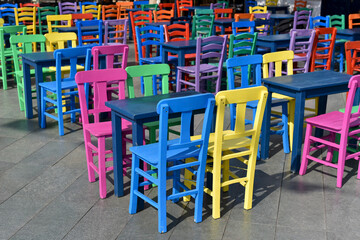 deserted outdoor cafe with multicolored wooden furnitures