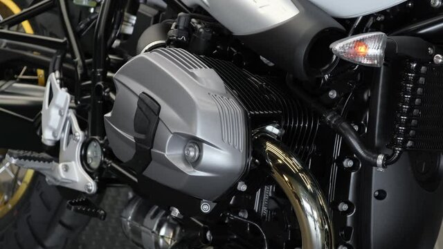 Closeup cinematic 4k footage on a motorcycle engine and other units in it. Dealer salon selling new motorbikes. 