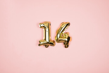 Gold foil balloons numeral 14 on pink background. Happy Valentines Day.